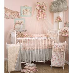 a baby crib in a pink and white nursery