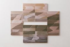 four pieces of wood are arranged on the wall