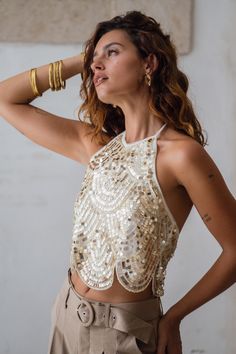 There's a best seller in a new color in town, introducing the Cleo Gold Top, a new colorway of the Cleo White Halter Top that we absolutely cannot keep in stock! With stunning gold sequins that cascade into a scallop hemline. Add her to your cart quickly before she sells out! Fitted Sequin Fabric For Festivals, Gold Sleeveless Top For Festival, Sleeveless Gold Top For Festival, Fitted Gold Top For Festivals, Chic Embellished Tops For Festivals, Gold Sequin Fabric For Summer Night Out, Gold Embellished Summer Top, Fitted Glamorous Gold Tops, Glamorous Gold Tops For Summer