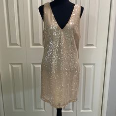 This Dress Is Sleeveless And Features A Deep V Neckline Front And Back, All Over Champagne Colored Sequined Detail In A Lightweight Fabric And Is Fully Lined. Perfect Party Dress For The Upcoming Holiday Season. Nwt. 34 1/2 Shoulder To Hem 19 Inches Pit To Pit E30 Sleeveless Gold Mini Dress For Date Night, Gold Sleeveless Mini Dress For Date Night, Gold Sleeveless Mini Dress For Spring, Glamorous V-neck Sleeveless Dress For Party Season, Gold Sleeveless Dress For Summer Nights, Glamorous Sleeveless Mini Dress For Spring, Sequin V-neck Sleeveless Dress For Night Out, V-neck Sleeveless Sequined Dress For Night Out, Gold Sleeveless Mini Dress For Summer