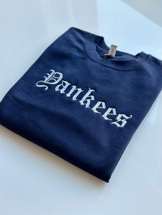 This is a Yankees inspired Crewneck sweater in Old English style font.  - Gildan brand sweatshirt 18000 - 1 x 1 ribbed knit collar, cuffs and waistband  - Ships in 2-3 business days ( Please message if needed sooner for expedited shipping options) - Ships from San Diego, CA ( Local San Diego customers generally receive their merchandise within 1 day after it has shipped and been received at USPS) Old English Style, Yankee Fitted, Baseball Jersey Women, Navy Embroidery, Baseball Sweatshirts, Embroidery Sweater, Baseball Women, Sweatshirt Crewneck, Tie Dye Sweatshirt