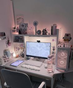 a desk with a computer monitor, keyboard and mouse