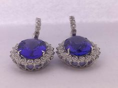 For Sale on 1stDibs - Natural Oval Tanzanite and Diamonds Earrings is set in 14K white Gold. Total weight of Tanzanite is 16.90 Carat and Total Diamond is 1.18 Carat. The earring Formal Oval Tanzanite Earrings, Tanzanite Round Wedding Earrings, Round Tanzanite Wedding Earrings, Tanzanite Round Earrings For Wedding, Formal Round Diamond Earrings With Gemstones, Tanzanite Earrings With Prong Setting, Round Tanzanite Earrings For Weddings, Round Tanzanite Earrings For Anniversary, Tanzanite Earrings For Anniversary