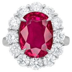 Crafted with meticulous attention to detail, this exquisite natural Ruby gemstone hails from the legendary mines of Mogok, Burma. Its captivating beauty is showcased within a bespoke, handcrafted setting made of solid platinum. The ring's design is elevated with a dazzling halo of round diamonds, meticulously selected and expertly set to accentuate the splendor of the central Ruby. These diamonds collectively weigh 2 carats, adding an enchanting brilliance to the piece. The Ruby itself boasts an Burmese Ruby, Garnet Engagement Ring, Mogok, Ruby Diamond Rings, Art Deco Diamond Rings, Platinum Diamond Rings, Gold Cocktail Ring, Diamond Cocktail Rings, Ruby Jewelry