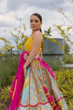 A multi-colored brocade mosaic scalloped lehenga paired with a yellow silk blouse and a pink tulle dupattaFrom Liz Paul’s Signature collection DELIVERY TIMEPlease allow 8-12 weeks for your outfit to arrive. FABRIC DETAILSRaw silk. Professional cleaning only. Anarkali Multicolor Brocade Choli, Multicolor Brocade Anarkali Choli, Yellow Silk Lehenga For Eid, Yellow Silk Choli For Eid, Multicolor Brocade Choli For Wedding, Multicolor Anarkali Brocade Sharara, Unstitched Yellow Silk Lehenga, Multicolor Silk Sets For Reception, Yellow Silk Sharara For Party