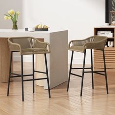 two wicker bar stools in front of a counter