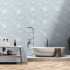 a white bath tub sitting next to a bathroom sink under a faucet on top of a wooden floor