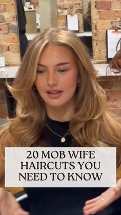 a woman holding a sign that says 20 mob wife haircuts you need to know