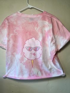 EVERY SHIRT IS SPECIAL AND UNIQUE AND DIFFERENT! Now that I got that out of the way, buying one of these custom, cute, cozy, cotton candy shirts is a great way to support Floof! This white cotton shirt from Hanes has been dyed pink and has our Floof Cotton Candy logo on the front and an adorable cotton candy cone on the back! These are unisex shirts but if you are in between sizes, I would size up. If you would like the shirt cropped please add it to the note! Shirt Information 5 oz./yd², 100% p Cute Soft-washed Pink T-shirt, Cute Pink Soft-washed Tops, Cute Soft-washed Pink Top, Cute Tie Dye Graphic T-shirt, Cute Tie-dye T-shirt With Graphic Print, Cute Tie Dye Graphic Print T-shirt, Cute Tie-dye Graphic Print T-shirt, Playful Tie Dye Short Sleeve T-shirt, Cute Pink Tops With Sublimation Print