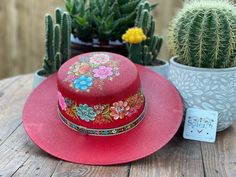 "This beautiful Mexican Hat is stylish and is completely unique in design, perfect to add that special touch to any outfit. This structured palm hat is often referred to as a women \"boater\" hat with its flat crown. The wide brim is accented by a hand painted band. The hat itself is made out of high quality jute and is very light and breathable. It is handmade and hand painted by Mexican Artisans in Mexico." Red Bohemian Straw Hat With Short Brim, Handmade Red Straw Hat With Curved Brim, Handmade Red Fedora With Flat Brim, Multicolor Brimmed Hat As Gift, Red Bohemian Hat For Kentucky Derby, Red Bohemian Brimmed Straw Hat, Bohemian Red Wide Brim Sun Hat, Handmade Red Wide Brim Straw Hat, Red Adjustable Bohemian Straw Hat