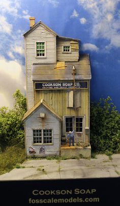 an image of a model of a house made out of wood and paint on the outside