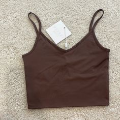 Meshki Willa V Neck Crop Cami Top Chocolate Brown New With Tags! Sold Out Online. Size Extra Small, Super Stretchy! Trendy Brown Camisole Top, Brown Seamless V-neck Top, Brown Stretch Cami Top, Stretch Brown Cami Top, Trendy Seamless Brown Tank Top, Trendy Brown V-neck Tank Top, Trendy Brown Cami Top, Brown Top With Built-in Bra For Spring, Casual Brown Tops With Built-in Bra