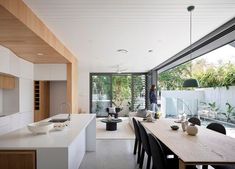 the kitchen and dining room are separated by sliding glass doors that lead out to an outdoor deck