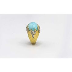 Capture the essence of the 1970s with this stunning 18K yellow gold turquoise ring. Crafted with meticulous attention to detail, this piece exudes vintage charm and timeless elegance. The focal point is a captivating dome oval turquoise gem, radiating with its vivid blue hue and natural allure.Surrounding the turquoise gem, a halo of 26 exquisite diamonds creates a mesmerizing frame that enhances the ring's beauty and adds a touch of sparkle. The diamonds delicately reflect the light, captivatin Vintage Yellow Gold Turquoise Ring For Formal Occasions, Luxury Blue Turquoise Ring For Formal Occasions, Vintage Gold Turquoise Ring For Formal Events, Gold Vintage Turquoise Ring For Formal Events, Vintage Gold Turquoise Ring For Formal Occasions, Gold Vintage Turquoise Ring For Formal Occasions, Heirloom Style Cabochon Turquoise Ring For Formal Occasions, Heirloom Yellow Gold Turquoise Ring For Formal Occasions, Luxury Yellow Gold Turquoise Ring For Formal Occasions