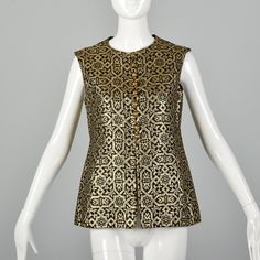 "This listing is for one vest. Textile is an unmarked mid weight fabric with gold on black pattern. Sleeveless vest features jewel neckline, brass toned buttons up the bodice, open slit at front, and side pockets. Condition Details: Very Good Condition. There are a few tiny frayed strands of gold thread along the front opening seams, this is typical of this type of fabric and does not detract from the presentation of the vest. Size Marked: Unmarked Approximate Size: Medium - Large **Please Check Gold Vest, Bohemian Vests, Gold Tapestry, Boho Vest, Style Vest, 70s Boho, Jewel Neckline, Gold Thread, Vest Outfits