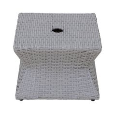 a white wicker stool with a black hole in the middle on an isolated background