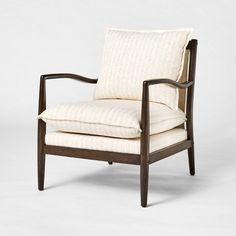 a wooden chair with white upholstered fabric on the back and armrests