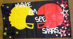 this is an image of a hand made banner with football helmets and paw prints on it