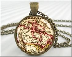 "This listing is for one round bronze plated vintage map pendant resin charm featuring an old antique map of Canada, circa 1852. A great gift for those who love history. Includes a matching link chain necklace. More Map pendants: www.etsy.com/shop/MGArtisanPendants?section_id=10456753 Don't see a map you're looking for? Ask me and I will see what I can come up with. Custom locations do incur an additional cost. * These beautiful picture pendants are made by me, in my home studio. * They are just over 1 inch in size(25mm). * Necklace lengths of 16, 18, 21 or 24 inches, or make request. * Pro quality printer used for the best reproduction possible. High detail level. * The pendants trays are a lead free zinc alloy casting. * Artwork is printed on the best high quality Canon photo paper. * Th Canadian Map, History Teacher Gifts, Canada Map, Map Jewelry, Picture Necklace, Map Pendant, Picture Pendant, Jewelry Picture, Resin Charms