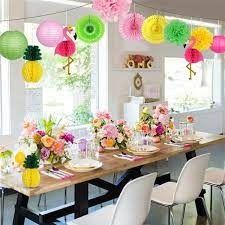 a long table is set with colorful paper lanterns