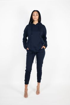 Casual but make it chic! This sweatsuit set includes a hooded tunic sweatshirt with a front pocket and slim fit jogger sweatpants. Complete the look with our 'Long Denim Jacket' and heels for an elevated streetwear outfit. Color: Navy Blue Model wearing size Small Runs true to size Fabric has stretch Cotton/Polyester blend Fall Tracksuit With Pockets For Loungewear, Fall Loungewear Tracksuit With Pockets, Fall Loungewear Tracksuit With Drawstring, Fall Tracksuit With Drawstring For Loungewear, Athleisure Sweats With Drawstring Hood For Lounging, Fall Season Hoodie Activewear For Loungewear, Fall Loungewear Activewear With Drawstring Hood, Fall Activewear With Drawstring Hood For Loungewear, Hoodie Sweats With Ribbed Cuffs For Lounging