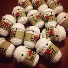 small crocheted coffee mugs with i love coffee on them are arranged together