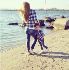 a mother and son playing on the beach