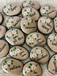 there are many decorated rocks with words on them