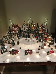 a christmas village is displayed on a table