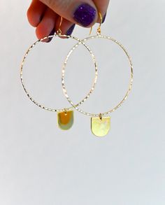 "These 14k gold fill geometric hoops are every girl's dream. As light as a feather, you can wear these from day into the evening. They're classic, chic, and effortless. The half-circle dangle charm is the cutest little addition to the hoop that makes it unique and full of magic. ▲ 14k gold fill 2\" hoops ▲ 24k gold plated brass charm ▲ Drop length: 3\" ▲ Weight: 1/8 oz ▲ Hypoallergenic ▲ Gift-ready in a beautiful white jewelry box ▲ Handmade just for you SHOP FIERCE FORWARD JEWELRY: https://www. Trendy Dangle Hoop Earrings In Brass, Everyday Nickel Free Dangle Hoop Earrings, Adjustable Hoop Earrings For Everyday, Modern Hammered Hoop Earrings As Gift, Trendy Brass Dangle Hoop Earrings, Modern Hammered Hoop Earrings For Gift, Modern Hammered Hoop Earrings Gift, Modern Brass Hoop Earrings For Everyday, Nickel-free Dangle Hoop Earrings For Everyday