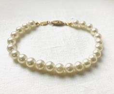 Berty And Gerty Vintage present this beautiful cream pearl beaded bracelet. Comes gift wrapped. Pearl Beaded Bracelets With Pearl Charm For Wedding, Cream Beaded Bracelets For Wedding, Cream Pearl Bracelet With Round Beads For Wedding, Cream Beaded Bracelets For Wedding With Round Beads, Cream Beaded Bracelets With Round Beads For Wedding, Adjustable Cream Pearl Bracelet, Adjustable Cream Bracelet For Wedding, Adjustable Cream Bracelet For Weddings, Vintage Pearl Bracelet With Round Beads For Wedding