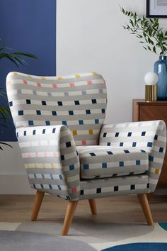 a living room with a chair and potted plant