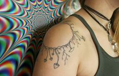 a woman with a tattoo on her shoulder