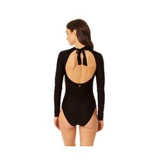 Our Coppersuit Long Sleeve One Piece swimsuit is the ultimate sleek rashguard for all your active days in the water. Our long sleeved rash guard provides extra coverage and UPF 50+ protection from the sun, while providing full range of motion. This stylish swimsuit is also designed with copper-infused fabric for antibacterial and odor-control properties to keep you feeling fresh all day long. An open-back tie detail and removable cups provide adjustable support and style. Hit the beach with this Fitted Solid Swimwear For Surfing, Fitted Black Long Sleeve Rash Guard, Solid Long Sleeve Beachwear Swimwear, Black Long Sleeve Swimwear Upf 50+, Black Long Sleeve Swimwear With Upf 50+, Fitted Rash Guard For Surfing, Solid Long Sleeve Rash Guard For Swimming, Solid Long Sleeve Swimwear For Poolside, Fitted Rash Guard With Thumbholes For Beach