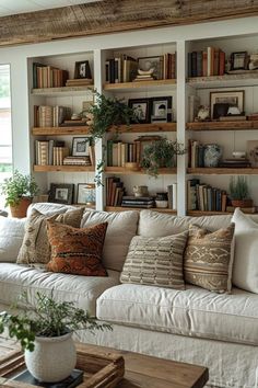 a living room filled with lots of furniture and bookshelves on top of each other