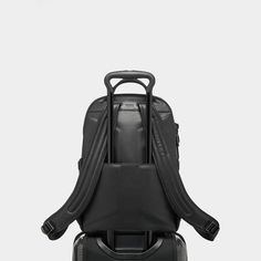 Tumi backpack is made of carbon fiber, leather, and polyester  Zip opening to main compartment Magnetic zipper pulls Zip entry to laptop compartment Luggage tag Top carry handle Add-a-Bag sleeve Built-in USB port  Two elastic open pockets Back open pocket; magnetic snap closure  Keyring Card pocket Two open pockets Padded tablet pocket TUMI Tracer® Approx. 9"L x 12"W Lining: Polyester Spot clean Imported Black Nylon Backpack For Business Trips, Functional Travel Backpack For Business Trips, Modern Backpack With Zipper For Business Trips, Modern Backpack With Zipper Closure For Business Trips, Modern Backpack For Business Trips With Zipper Closure, Business Trip Backpack With Functional Pockets, Modern Nylon Backpack, Black Anti-theft Backpack For Business Trips, Modern Nylon Leather Backpack With Zipper