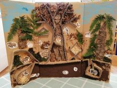 an art project made out of cardboard with trees and animals