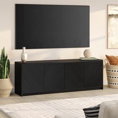 a large flat screen tv mounted to the side of a wall in a living room