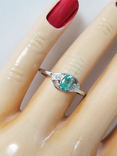 "Thanks for shopping our vintage estate store. We tend to sell well below wholesale and truly hope you enjoy all of our items. Many of the items are one of a kind, so please enjoy scrolling through the pictures and hopefully something will catch your eye. Brown spots are from the camera. Estate ring nice sterling silver 925 natural .25ct emerald with 2 small diamonds. Custom made ring, meaning we set the gem into the setting. Ring size: please select a size Setting: 3/8\" 8mm Band width: 1.5mm W Vintage Silver Oval Emerald Ring, Vintage Oval Emerald Ring Gift, Vintage Oval Emerald Ring For Gift, Vintage Oval Birthstone Diamond Ring, Hallmarked Oval Emerald Ring Collectible, Collectible Oval Emerald Ring In Sterling Silver, Vintage White Gold Oval Emerald Ring, Vintage Oval White Gold Emerald Ring, Vintage Oval Emerald Ring In White Gold