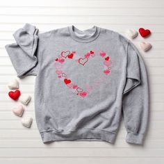 Introducing our Love Sweatshirt, the perfect addition to your wardrobe that will make you feel cozy, stylish, and loved! This Cute Hearts Sweatshirt is not only a fashion statement but also a heartwarming Valentines Day gift for women, celebrating the season of love and affection. Our Love Sweatshirt is crafted with the utmost care and attention to detail. Made from high-quality, soft, and breathable fabric, this sweatshirt offers unparalleled comfort and warmth. Whether you’re lounging at Women Celebrating, Valentines Sweatshirt, Valentines Day Sweatshirt, Cute Hearts, Love Sweatshirt, Funny Sweaters, Heart Sweatshirt, Sweatshirt Cute, Different Outfits