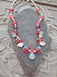 "Colorful gemstone necklace in rich vibrant colors that will remind you of sea, beach an summer. This necklace will look great with white ,black, blue and anything in-between. It is had strung with chalcedony brioletts, fresh water pearls, coral and sterling silver elements. This is a real treat for a lady who likes one of a kind and not so typical pieces. The necklace is a choker style and measures 17\" Please see matching earrings https://www.etsy.com/listing/1557944640/blue-chalcedony-peals-a Multicolor Gemstone Jewelry For Beach, Ocean-inspired Colorful Bead Necklaces For Gifts, Ocean-inspired Colorful Beads Necklace For Gift, Ocean-inspired Colorful Beads Necklace Gift, Gift Ocean-inspired Colorful Beads Necklace, Handmade Ocean Color Necklaces For Jewelry Making, Natural Stone Strand Jewelry As Gift, Strand Jewelry With Natural Stones As A Gift, Gift Jewelry With Natural Stones In Strand Shape