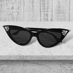 Step into the world of daring fashion with our spiderweb sunglasses. These captivating shades feature an intricately designed spiderweb pattern on a sleek frame, creating a mesmerizing visual effect. These sunglasses offer both style and comfort, making them perfect for any sunny day adventure. Suitable for both men and women, these sunglasses are the ultimate accessory to elevate your look and make a bold statement wherever you go. Embrace your unique sense of style and let your eyes weave thei Festival Cat Eye Tinted Sunglasses, Black Glass Sunglasses For Festival, Halloween Sunglasses With Tinted Lenses, Halloween Tinted Sunglasses, Halloween Tinted Plastic Sunglasses, Black Sunglasses With Gradient Lenses For Festival, Black Tinted Sunglasses For Festival, Retro Black Sunglasses For Festival, Black Retro Sunglasses For Festival