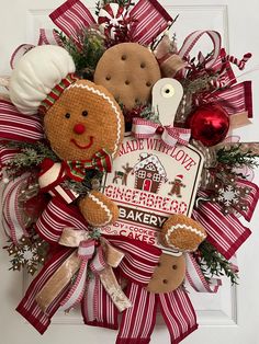 a christmas wreath with gingerbreads and other holiday decorations