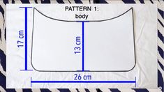 an image of a white sheet with blue lines on it and measurements for the pattern