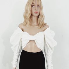 Elevate Your Style With The Seraphim Lace-Up Bow Top From Sustainable Fashion Brand Nathalia Jmag.&Nbsp; The Linen Top Features A Front Bow Bralette And Puffed Sleeves. The Meticulous Details Truly Set This Piece Apart, Adorned With Lace-Up Sleeve Cuffs And An Adjustable Corset Style Lace-Up Back With Oversized Grommets. Yet, Beyond Its Aesthetic Splendor Lies A Deeper Commitment. Crafted From Deadstock Fabric And Tailored To Order Or Sewn In Small Batches, Each Nathalia Jmag Creation Embraces Sustainability Without Compromise. Because True Style Isn't Just About Making A Statementit's About Making A Difference, One Impeccably Crafted Garment At A Time. ****Note- The Xs And Small Are Br White Fitted Off-shoulder Blouse, Fitted Off-shoulder White Blouse, White Stretch Feminine Crop Top, White Evening Crop Top, White Off-shoulder Crop Top For Parties, White Off-shoulder Party Blouse, White Cropped Tops For Evening, White Off-shoulder Crop Top For Brunch, White Off-shoulder Crop Top For Night Out