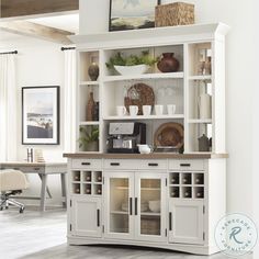 a large white bookcase with glass doors and drawers in the middle of a room