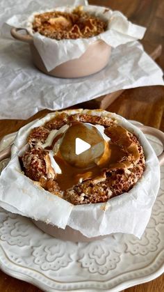 two bowls filled with food sitting on top of a wooden table next to each other