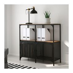 two black bookshelves sitting next to each other on a rug in front of a white wall