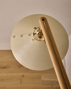 an overhead view of a table with a clock on it and a wooden stick sticking out of the top