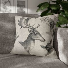 a deer pillow sitting on top of a couch